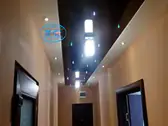 Опънат таван в коридор - черен лак с RGB кристали, които си сменят цвета.