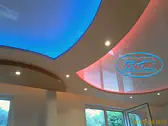 Огледални светещи опънати тавани с RGB LED ленти в хол.